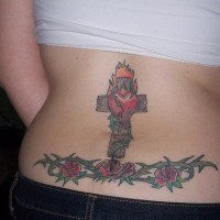 Cross with roses lower back tattoo