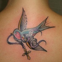 Flying sparrow with cross back tattoo