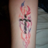 Classic cross in colourful flames tattoo