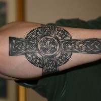 Celtic style cross tattoo on forearm