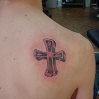 Stone cross tattoo on shoulder
