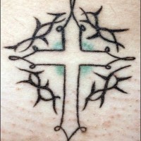 Minimalistic cross with tribal tracery tattoo
