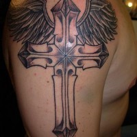 Winged cross black ink tattoo on shoulder