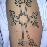 Cross tracery tattoo on arm