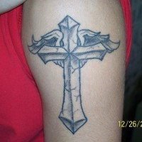 Winged cross tattoo on arm