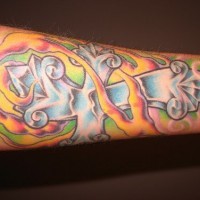 Crystal cross coloured arm tattoo
