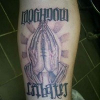 Symmetrical praying hands tattoo on arm