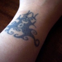 Black tracery wrist tattoo