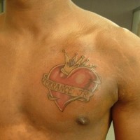 Crowned heart chest tattoo