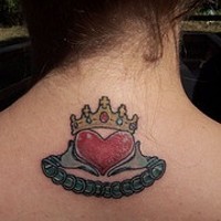 Claddagh ring symbol on back tattoo