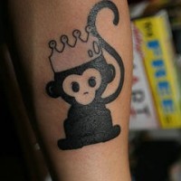 Black monkey in crown tattoo