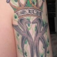 Kk in crown on green flames tattoo