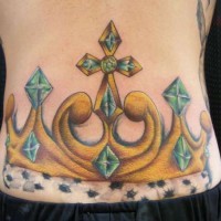 Large golden crown lower back tattoo