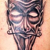 Horned devil mask tattoo