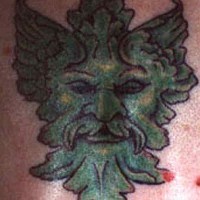 Green scandinavian demon face tattoo