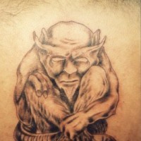 Old satyr tattoo on back