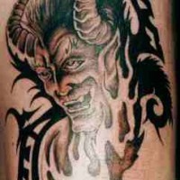 Laughing horned demon tattoo