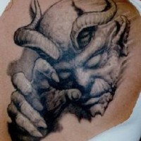 Horned devil black ink tattoo