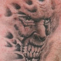 Angry demon face tattoo
