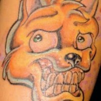 Crazy cartoonish yellow dog tattoo