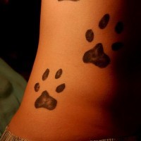 Three dog paw prints tattoo