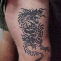 Tribal dragon tattoo on leg