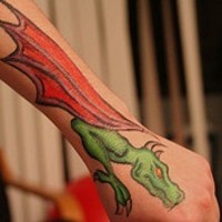 Green dragon with red wings tattoo