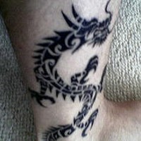 Black ink tribal dragon tattoo