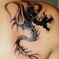Tribal dragon shoulder tattoo