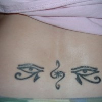Eyes of horus tribal tattoo on tail base
