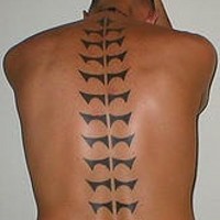 Tribal backbone black ink tattoo