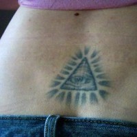 All seeing eye tattoo on lower back