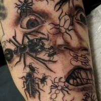 Scared face with insects tattoo