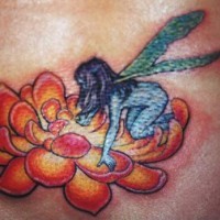 Blue fairy on orange flower tattoo