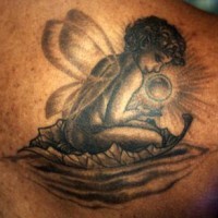 Fairy with magic sphere black ink tattoo