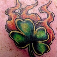 Four leaf clover in flame tattoo