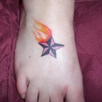 Flaming nautical star tattoo on foot