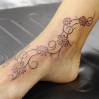 Thin curled branches with flowers foot tattoo