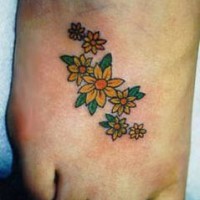 Yellow flowers tattoo on foot