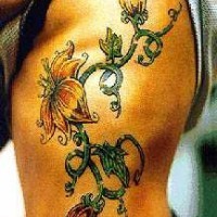 Flower blossoms on side tattoo
