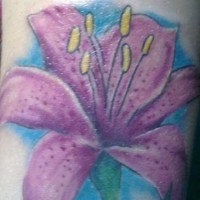 Purple flower with blue background tattoo on wrist