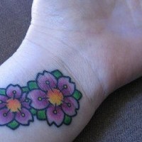 Tatuaggio colorato sul polso i fiori
