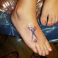 Le tatouage sur le pied de cœur et des ciseaux