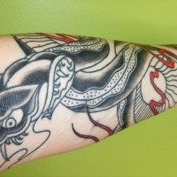 Evil viper with sharp teeth forearm tattoo