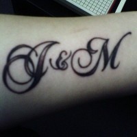 Two styled letters,brief name  forearm tattoo