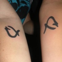 Identical symbols of friendship tattoos