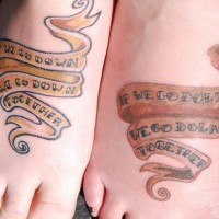 Identical stripe tattoos on friends feet