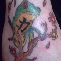Frog on sakura tree with hieroglyphs tattoo