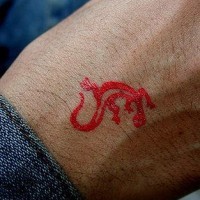Red lizard symbol tattoo on hand