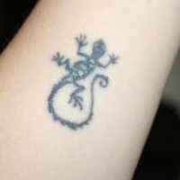 El tatuaje pequeño de una lagartija de color negro